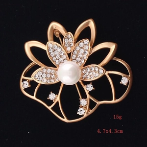 Detail view of lotus flower brooch with pearls and rhinestones measuring 4.7x4.3cm