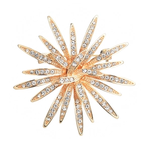 Elegant gold sunburst brooch featuring radiant white rhinestones and a sparkling snowflake design