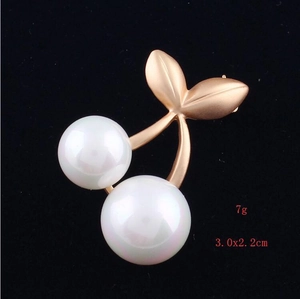 Detail view of matte gold cherry brooch with faux pearls showing 3.0x2.2cm dimensions