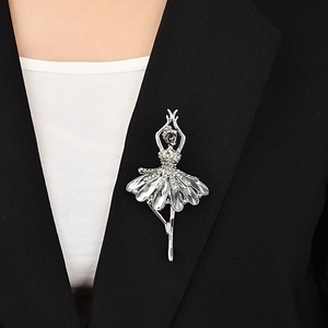 Detail of a sparkling ballerina brooch with white crystals on a black suit jacket
