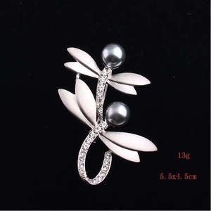 Detail of matte silver double dragonfly brooch with dark grey pearls and rhinestones