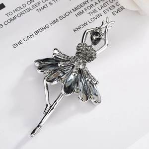 Elegant silver ballet dancer brooch with grey crystals on decorative white background