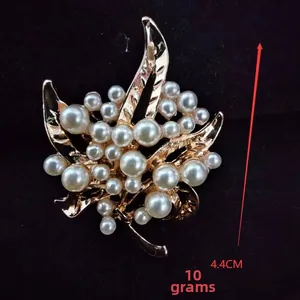 Detail view of leaf brooch with dimensions 4.4cm and weight 10g with gold finish and pearls