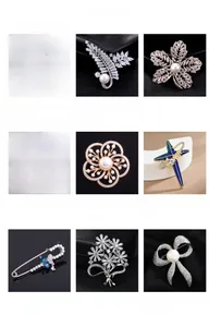 Macro view of various jewelry brooches featuring leaf, flower, and starfish designs