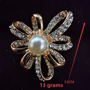 Macro detail of luxury flower brooch with pearl inlay and crystals, size 3.8cm, 13g