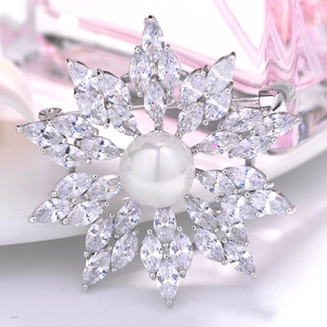 Elegant snowflake brooch with a large pearl and sparkling zircon petals on silver base