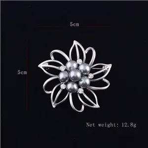 Detail view of silver floral brooch with grey pearl showing 5cm size and 12.8g weight