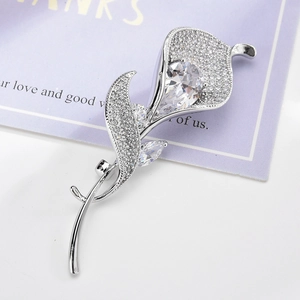 Elegant silver calla lily brooch with shimmering pavé zircon and a pear-shaped stone
