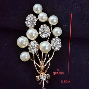Macro detail of rose gold floral brooch with pearls and rhinestones measuring 5.5cm
