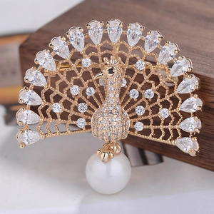 Exquisite gold peacock brooch with sparkling zircons and a large white pearl drop