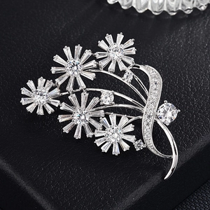 Détail macro d'une broche bouquet avec zircons clairs sur fond en cuir noir