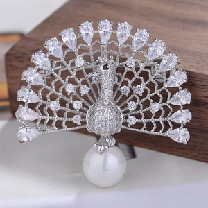 Detail of silver peacock brooch featuring zircon stones and a large white pearl drop