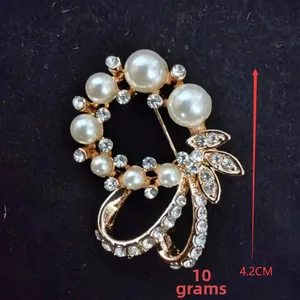 Detailed view of luxury flower brooch with pearls and rhinestones measuring 4.2cm height