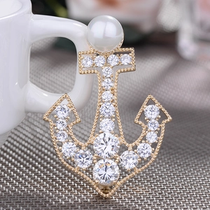 Golden anchor brooch with crystals and large white pearl for nautical elegance style