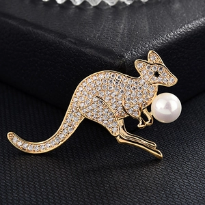 Détails macro d'une broche kangourou dorée avec cristaux incrustés et une perle élégante
