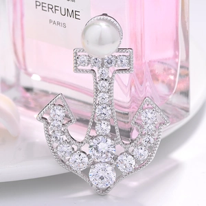 Elegant nautical anchor brooch featuring white pearls and zircon pavé in silver tone