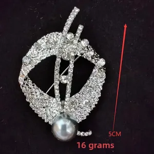 Detail view of flower brooch with rhinestones and grey pearl, size 5cm, weighing 16g