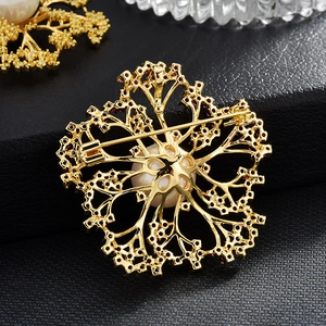 Eleganter Kamelien-Brosche in Gold mit roten Zirkonia-Zweigen und großer weißer Perle