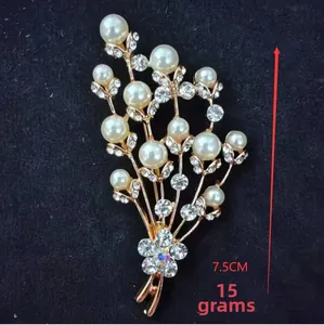 Detail view of flower brooch showing 7.5cm length with gold plating and white pearls