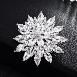 Exquisite silver snowflake brooch with marquise-cut zircon stones on a black leather base