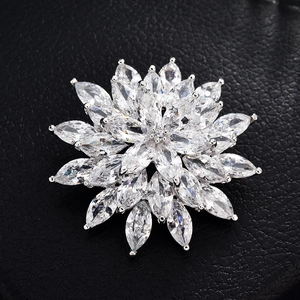 Macro detail of silver flower brooch featuring marquise-cut cubic zirconia in sunburst pattern