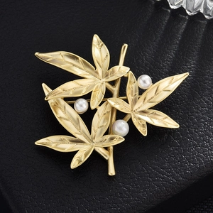 Elegant matte gold bamboo leaf brooch with white pearls for suits and coats