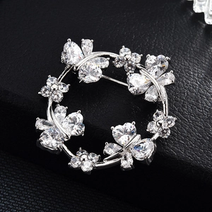 Silver flower and butterfly wreath brooch with sparkling heart-shaped cubic zirconia