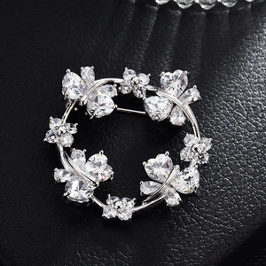 Elegant silver ring brooch with sparkling cubic zirconia butterfly and floral wreath design