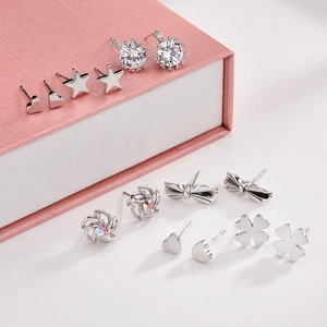 Close-up of 925 silver stud earrings set featuring heart, star and floral designs