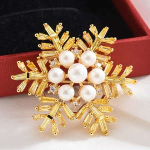 Broche flocon de neige élégante avec cristaux baguette jaunes et monture en alliage doré