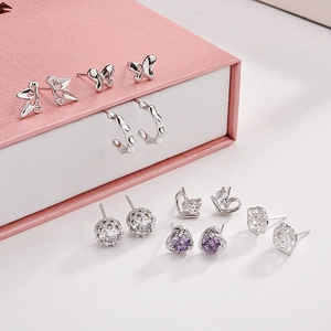 Detail of 925 sterling silver earring set featuring butterfly and heart zircon studs