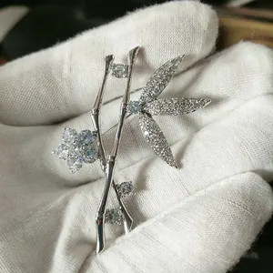 Detailed macro view of silver bamboo brooch with sparkling zircon inlays for women
