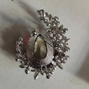 Macro detail of the brooch back with silver metal frame and pin fastener mechanism