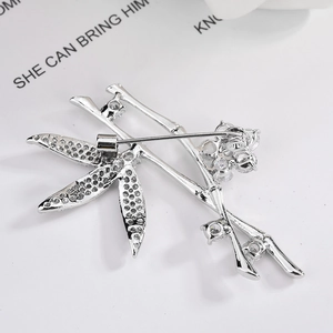 Elegant silver bamboo brooch with sparkling zircons, close-up of the stylish back pin structure