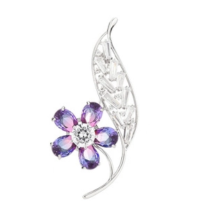 Detail of floral brooch with purple gradient gemstones and white zircon in silver setting