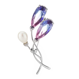 Detailed view of flower brooch with gradient purple gemstones and a white pearl accent