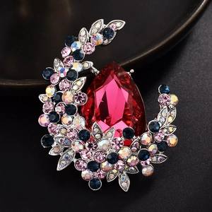 Elegant crystal brooch with large red teardrop gemstone and multicolored rhinestones