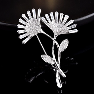 Detailed macro of silver-plated flower brooch with baguette and round cut crystals