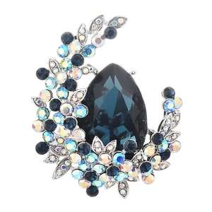 Elegant silver brooch with large pear-shaped blue crystal and floral rhinestone details