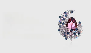 Detail of Austrian crystal brooch featuring pear-shaped wine red stone and blue gems