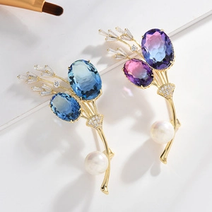 Macro shot of elegant flower brooches with gradient crystals and white pearls