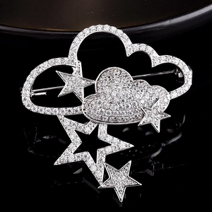 Detailed close-up of cloud and star brooch featuring silver plating and zircon inlay