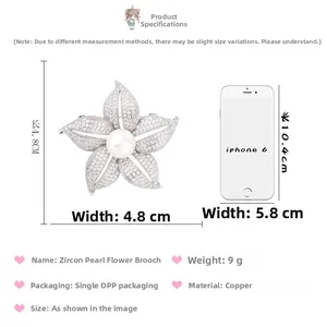 Detail showing pearl flower brooch dimensions of 4.8cm beside an iPhone for size scale