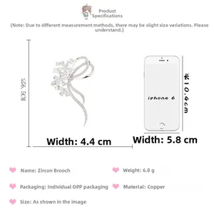 Detailed size specifications of ribbon bow cubic zirconia brooch with iPhone 6 reference
