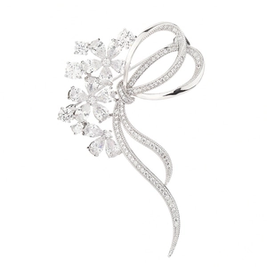 Elegant silver flower bow brooch with sparkling cubic zirconia on white background