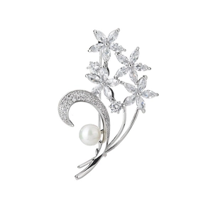 Élégante broche fleur argentée avec zircone et une perle blanche sur fond blanc pur
