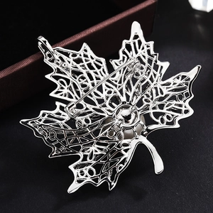 Elegant maple leaf brooch with pearl inlay and detailed hollow silver mesh backing