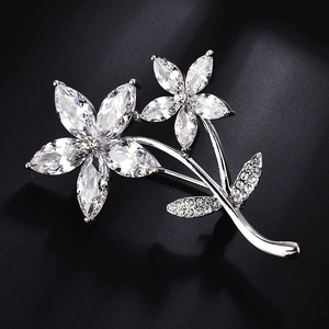 Elegant silver flower brooch with marquise zirconia stones on a premium black background