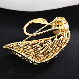 Detailed back view of golden swan brooch with secure pin clasp and zircon setting