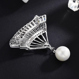 Elegant fan-shaped zircon brooch with white pearl pendant for women on black surface